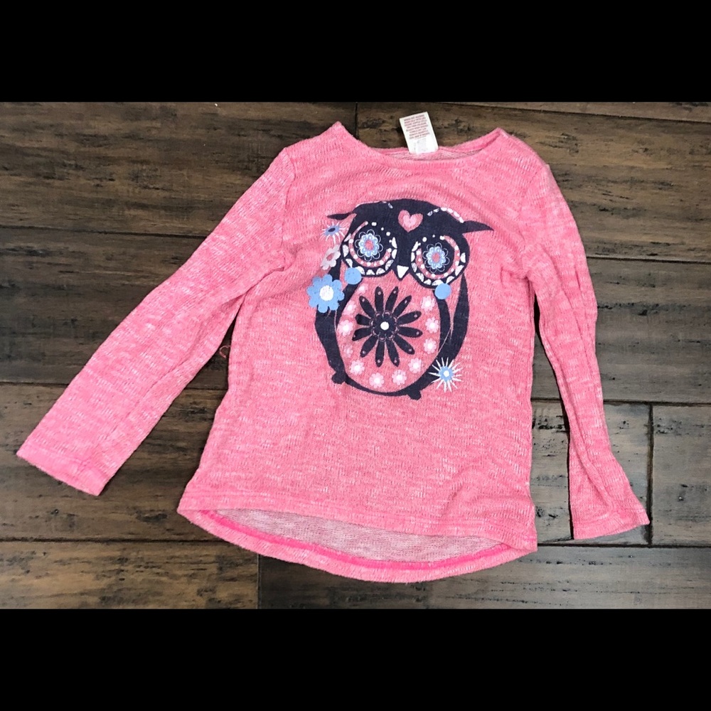 Pink long-sleeves child’s shirt with an owl design